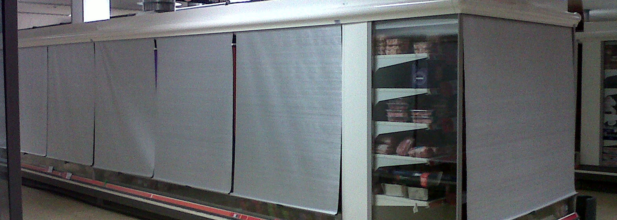 Image of a vertical open-air grocery display case with vertical covers.